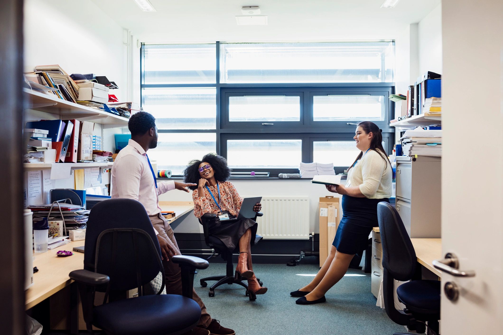 Team members talking together in an office